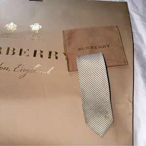 Men’s Burberry Gold tie with signature logo.